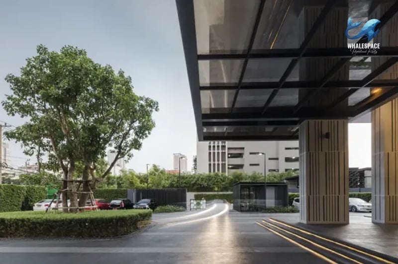 Grand main entrance and drop-off area with a modern canopy and landscaped surroundings.