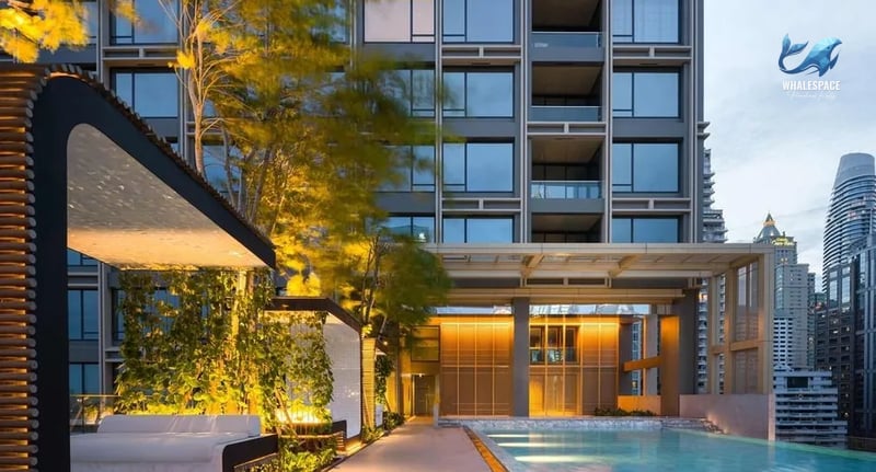 Infinity swimming pool with elegant cabanas and city views.