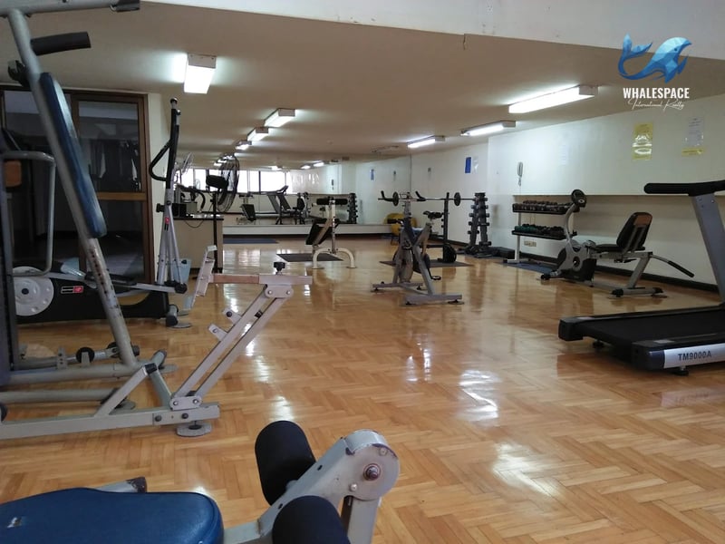 Spacious fitness center with various cardio and weight training machines