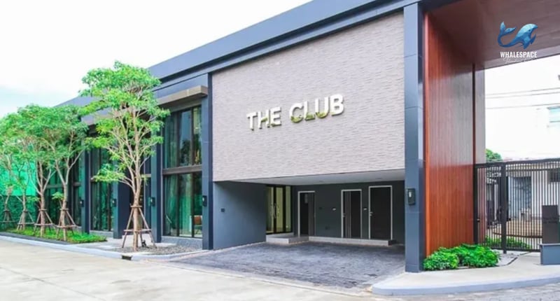 Elegant building entrance labeled 'THE CLUB' with sleek modern design
