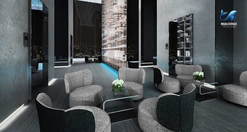 Sophisticated lounge area with several curved, grey fabric armchairs, glass coffee tables, and soft, ambient strip lighting.