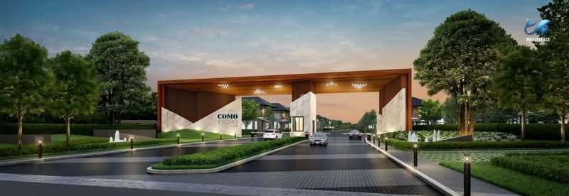 Grand entrance gate with modern architecture and landscaping, leading to a residential community.