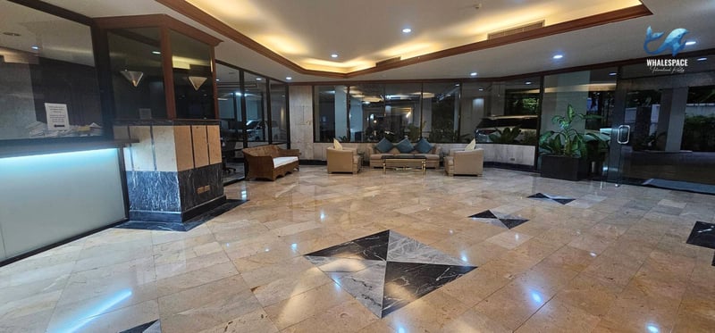 Elegant marble-floored lobby with comfortable seating and ambient lighting