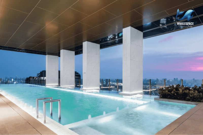 Stunning infinity pool offering breathtaking city skyline views at dusk