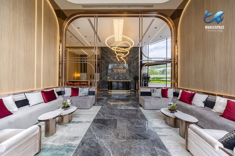 Elegant lobby with sophisticated seating arrangements, a striking chandelier, and marble flooring, creating a grand first impression.