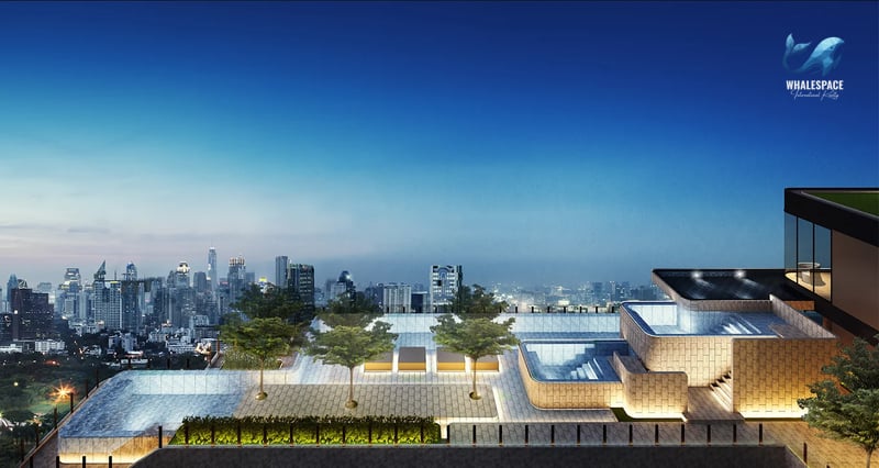Rooftop pool area with stunning city skyline views during the evening.