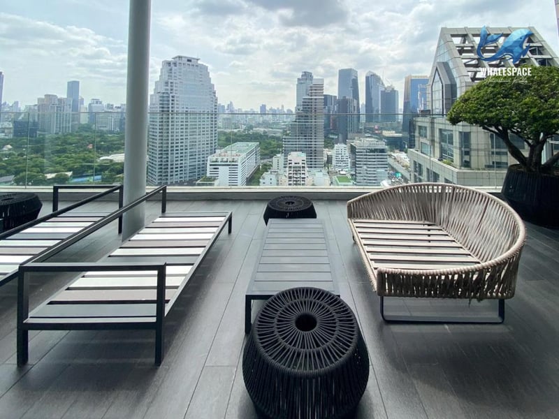 Elevated outdoor lounge area with stylish seating and panoramic city views