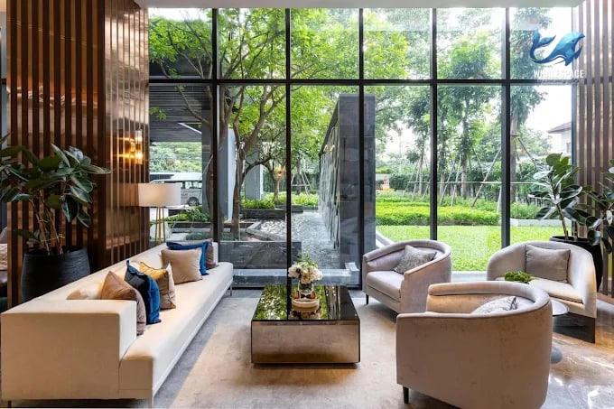 Elegant lobby with comfortable seating and large windows overlooking a lush garden.