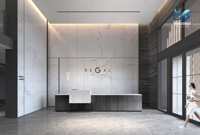 Elegant reception area with marble walls, a modern counter, and sophisticated lighting.