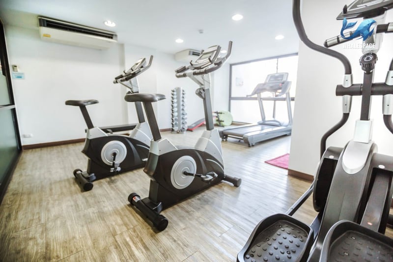 Well-equipped fitness center with cardio machines and weights