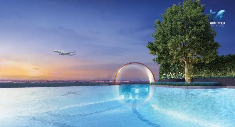 Stunning infinity pool offering breathtaking sunset views, with a striking architectural arch in the distance.