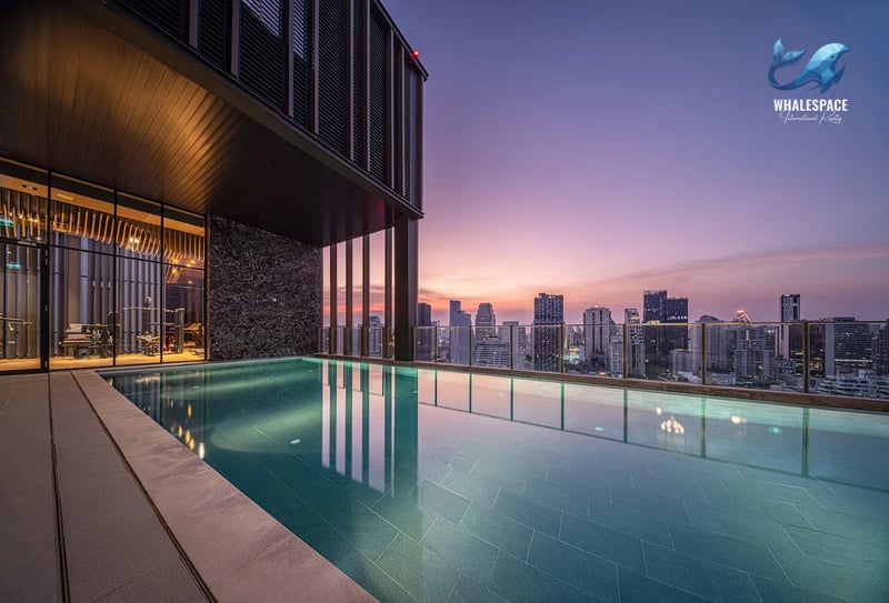 Stunning infinity pool overlooking a cityscape at dusk