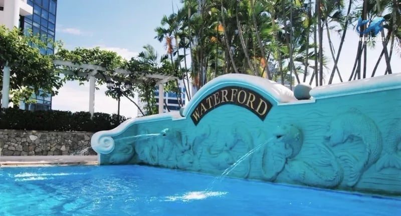 Decorative water feature with intricate carvings at the edge of the swimming pool