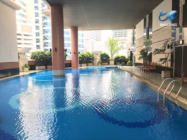 Expansive swimming pool with a striking mosaic design on the bottom.