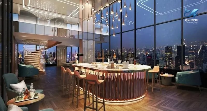 Elegant sky bar with a curved counter, stylish pendant lighting, and panoramic city skyline views at night.