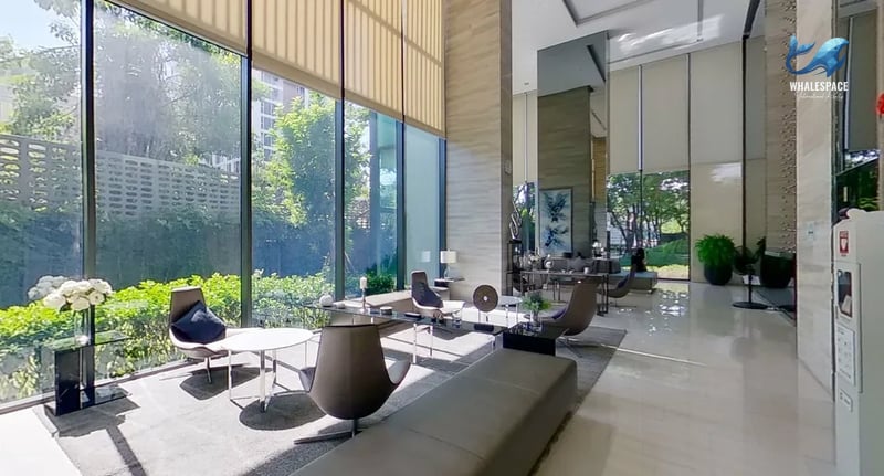 Spacious lobby with high ceilings, abundant natural light, and elegant seating areas