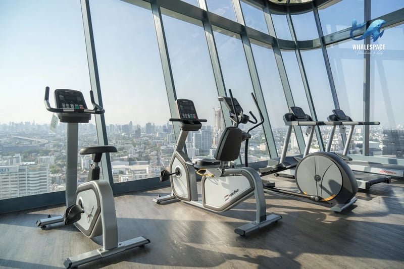 Well-equipped gym with cardio machines and expansive city vistas