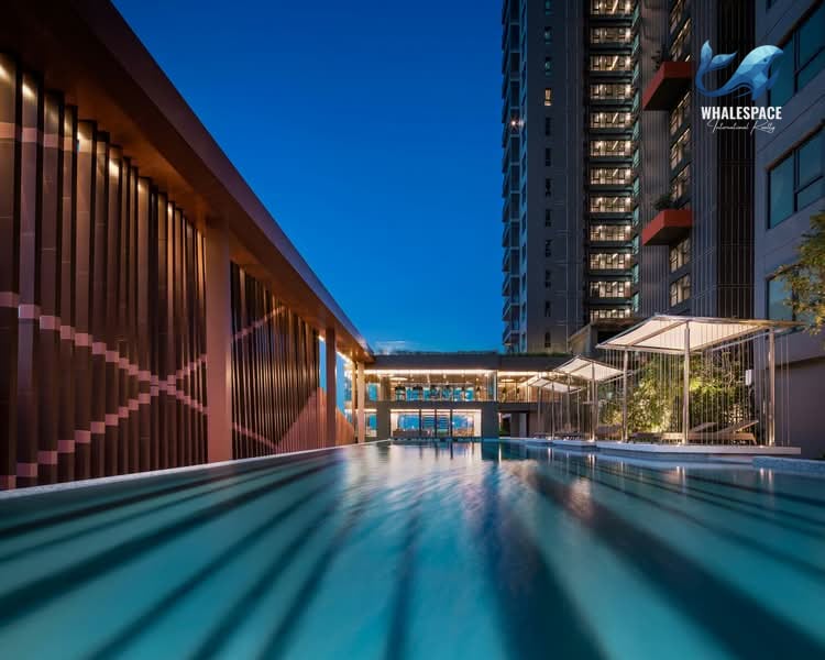 Infinity swimming pool overlooking the city skyline with cabanas and lounge seating