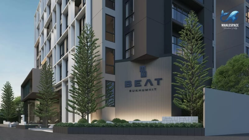Modern condominium building facade with geometric design and lush greenery.