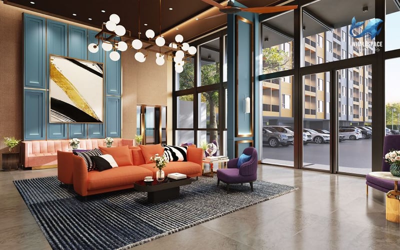 Grand lobby with a striking orange sofa, stylish blue wall panels, and large windows overlooking the exterior parking.