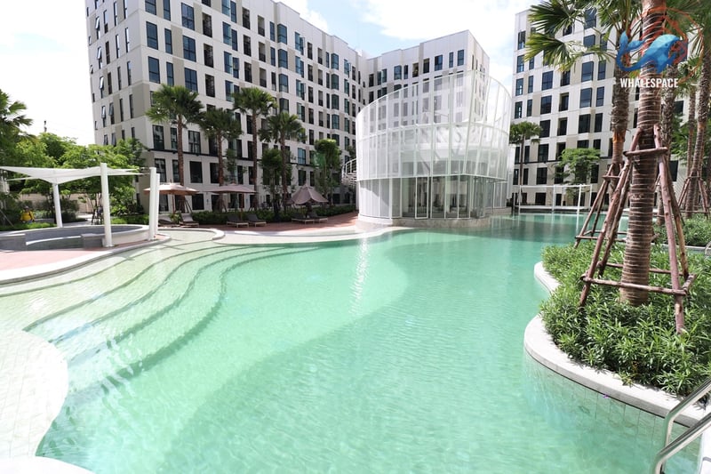Expansive swimming pool with unique tiered levels and surrounding lush landscaping.