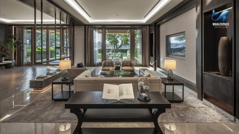 Luxurious grand lounge or lobby with elegant dark wood paneling, polished marble floors, and a serene garden view.