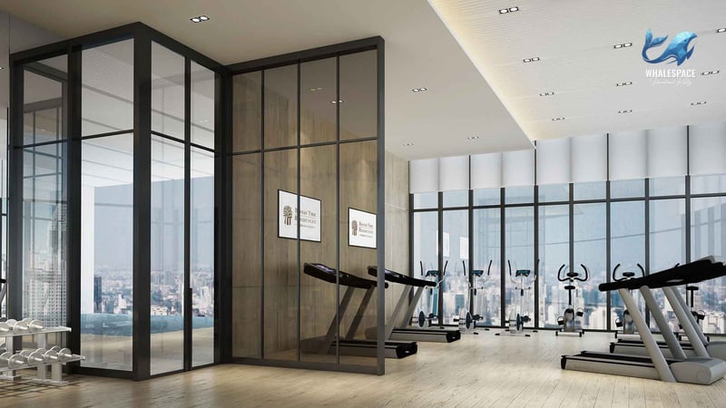 State-of-the-art fitness center with treadmills and ellipticals, overlooking a city view.