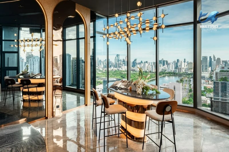 Stylish high-floor lounge with a bar setup, contemporary lighting, and floor-to-ceiling windows revealing city and park views