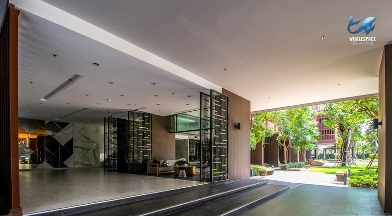 A grand entrance leading to a spacious lobby with a mix of seating areas and architectural features.