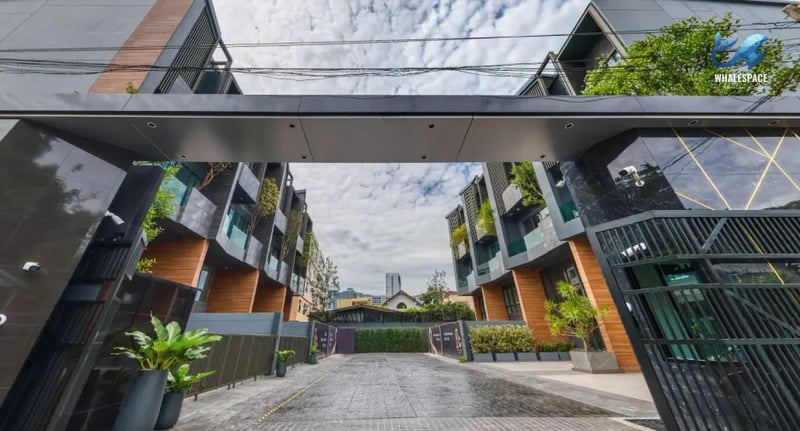 Grand entrance to a modern townhouse development with sleek architecture