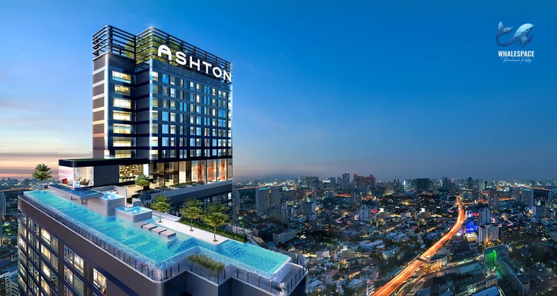 Modern high-rise condominium building with 'ASHTON' signage and a rooftop infinity pool overlooking a cityscape at dusk.