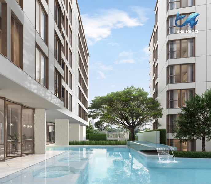 Inviting swimming pool with modern architecture and lush greenery surrounding the building.