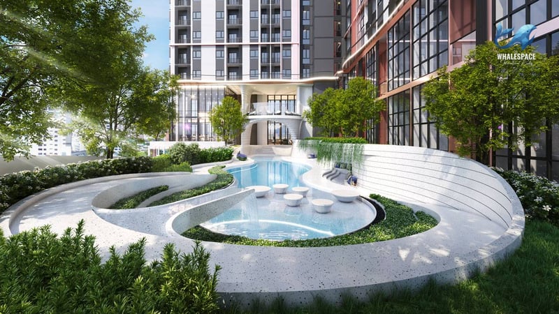 Sculptural swimming pool surrounded by lush greenery and modern seating areas.
