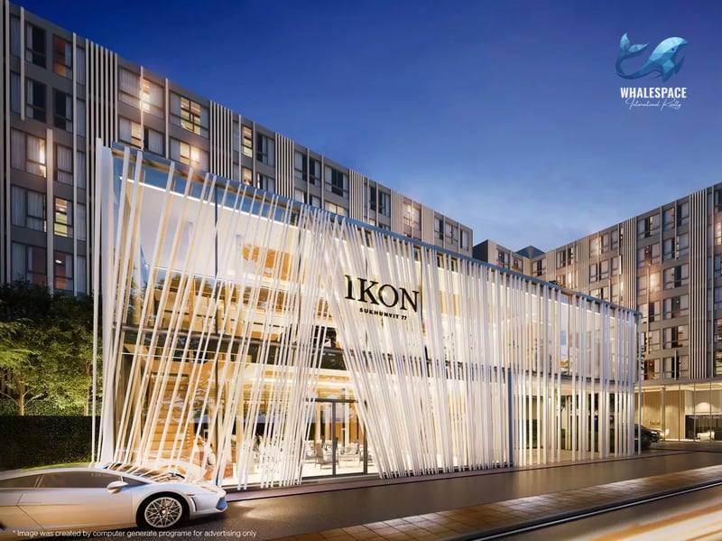 Modern building facade with unique vertical architectural elements and illuminated signage at dusk.