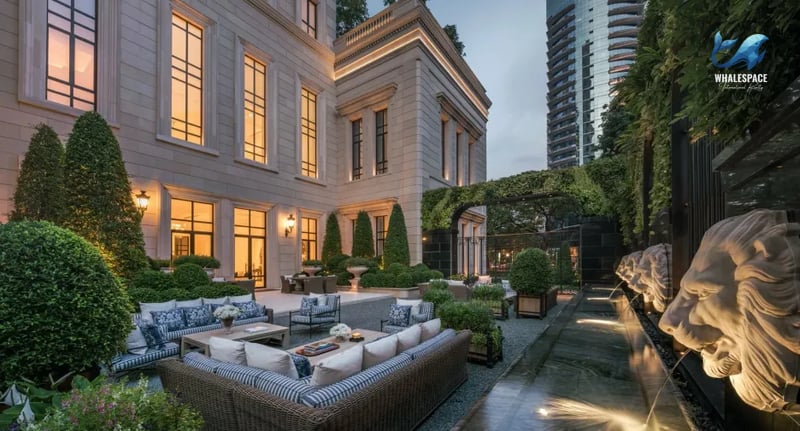 Lush courtyard garden with sculpted hedges, comfortable outdoor seating, and a serene water feature with lion head spouts
