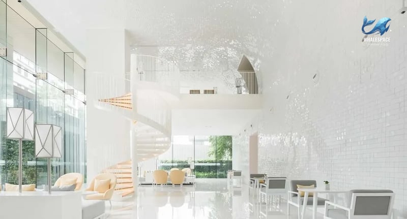 Grand lobby with a striking spiral staircase and elegant seating arrangements.