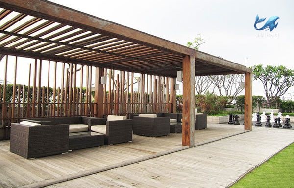 Covered outdoor lounge area with comfortable seating and city views