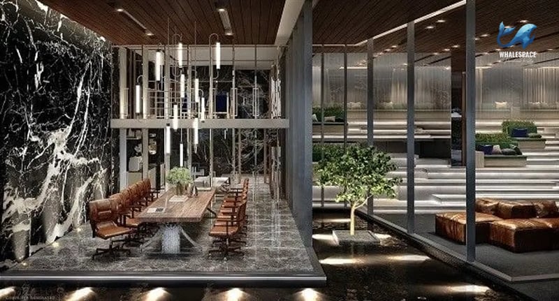 Luxurious lobby area featuring a grand conference table, marble accent walls, and contemporary lighting.