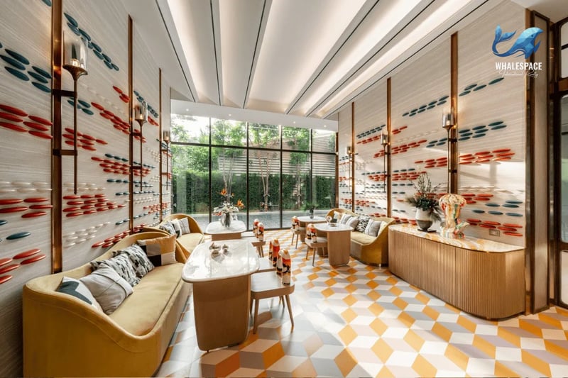 Inviting lounge space with comfortable seating arrangements and vibrant, geometric floor tiles