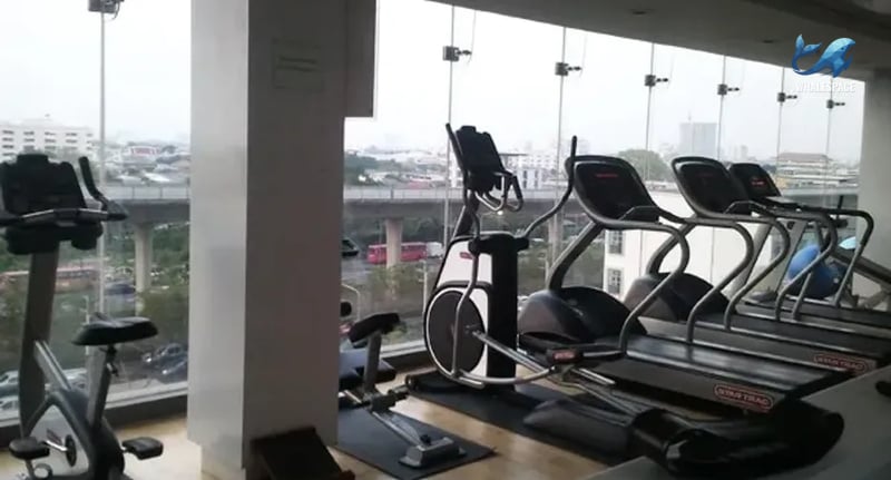 Fully equipped fitness center with cardio machines and treadmills offering panoramic city views.