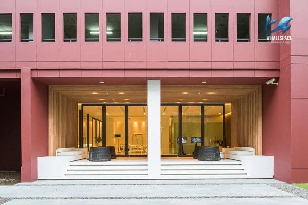 Elegant building entrance with double doors and outdoor seating areas