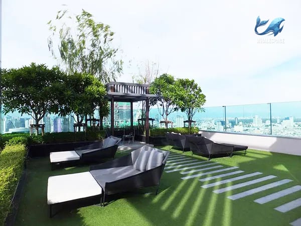 Rooftop garden lounge area with comfortable seating and lush greenery.