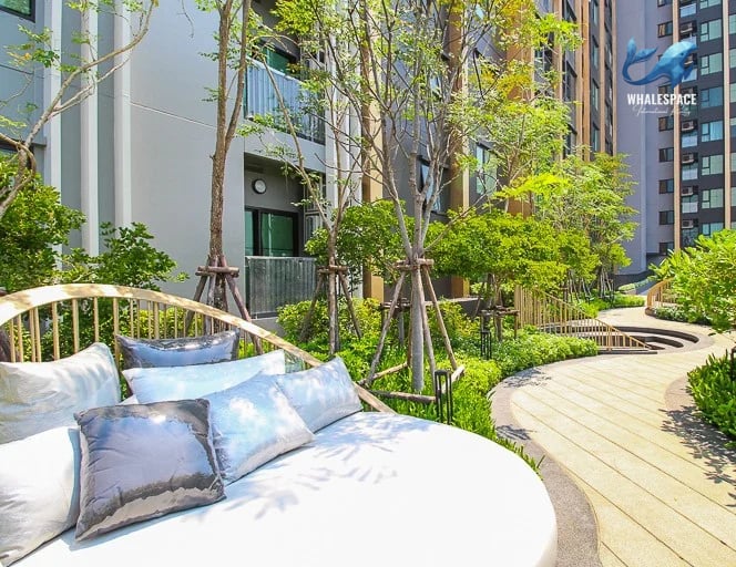 Tranquil garden path with lush greenery and comfortable outdoor seating