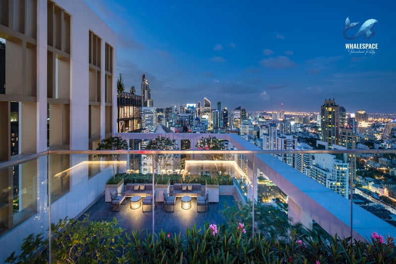 Expansive rooftop terrace offering panoramic city views at twilight, with elegant lounge seating and chic outdoor lighting.