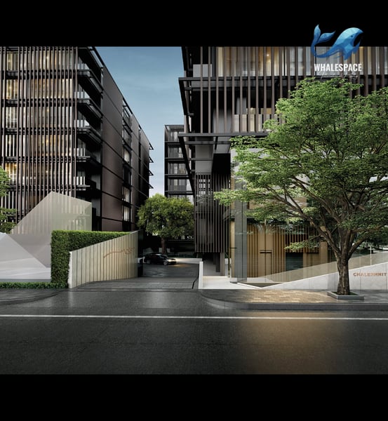 Modern condominium entrance with green landscaping and architectural facade