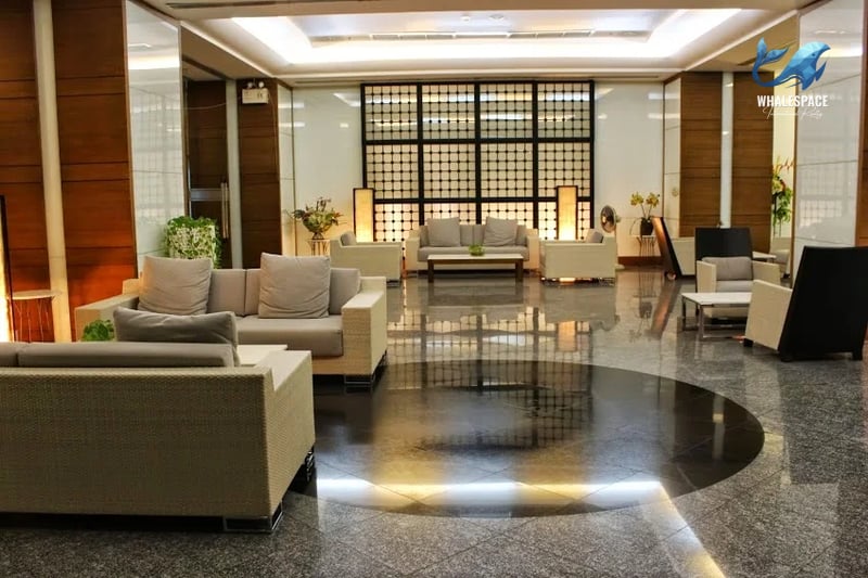 Elegant lobby lounge with polished granite floors, comfortable seating, and stylish ambient lighting