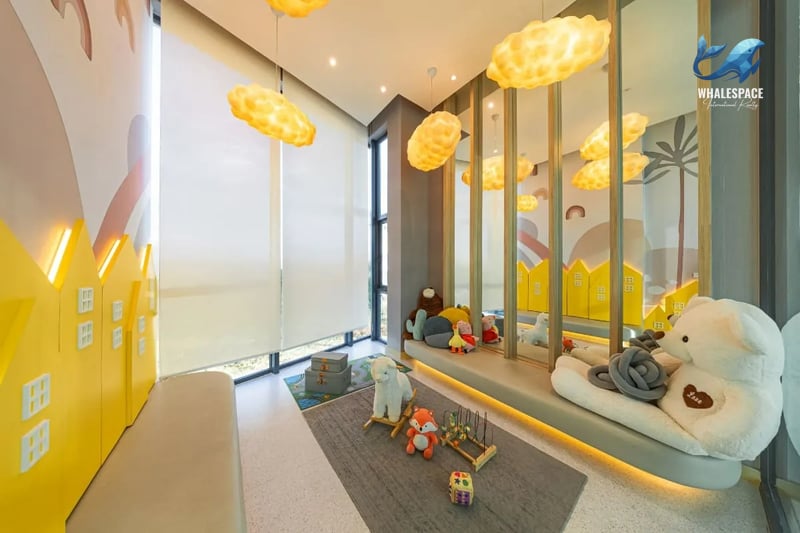 Vibrant children's play area with whimsical cloud lights, colorful wall murals, and a variety of toys