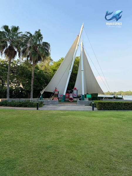 Vibrant green lawn with a unique sailboat-themed playground structure