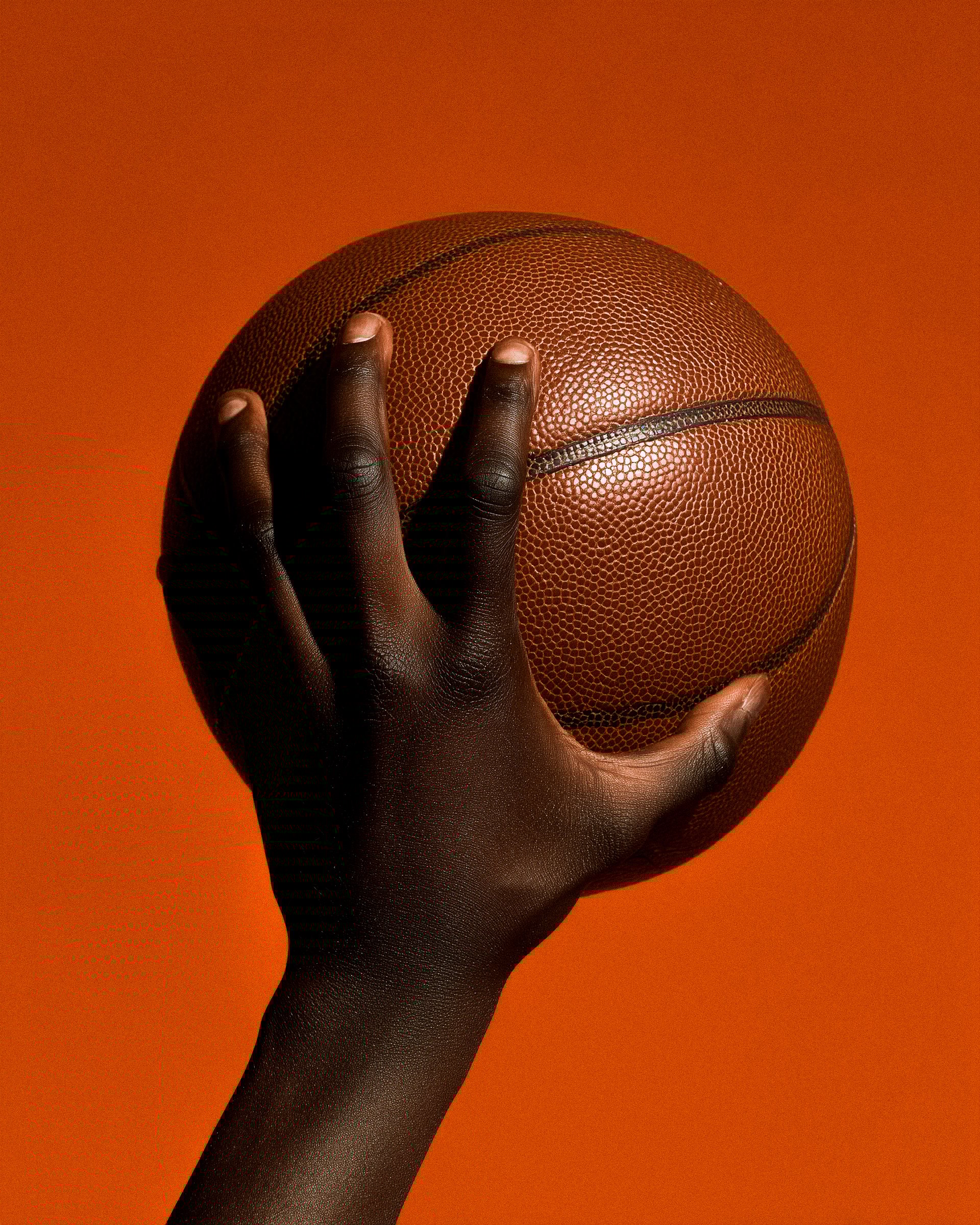 Hand holding basketball
