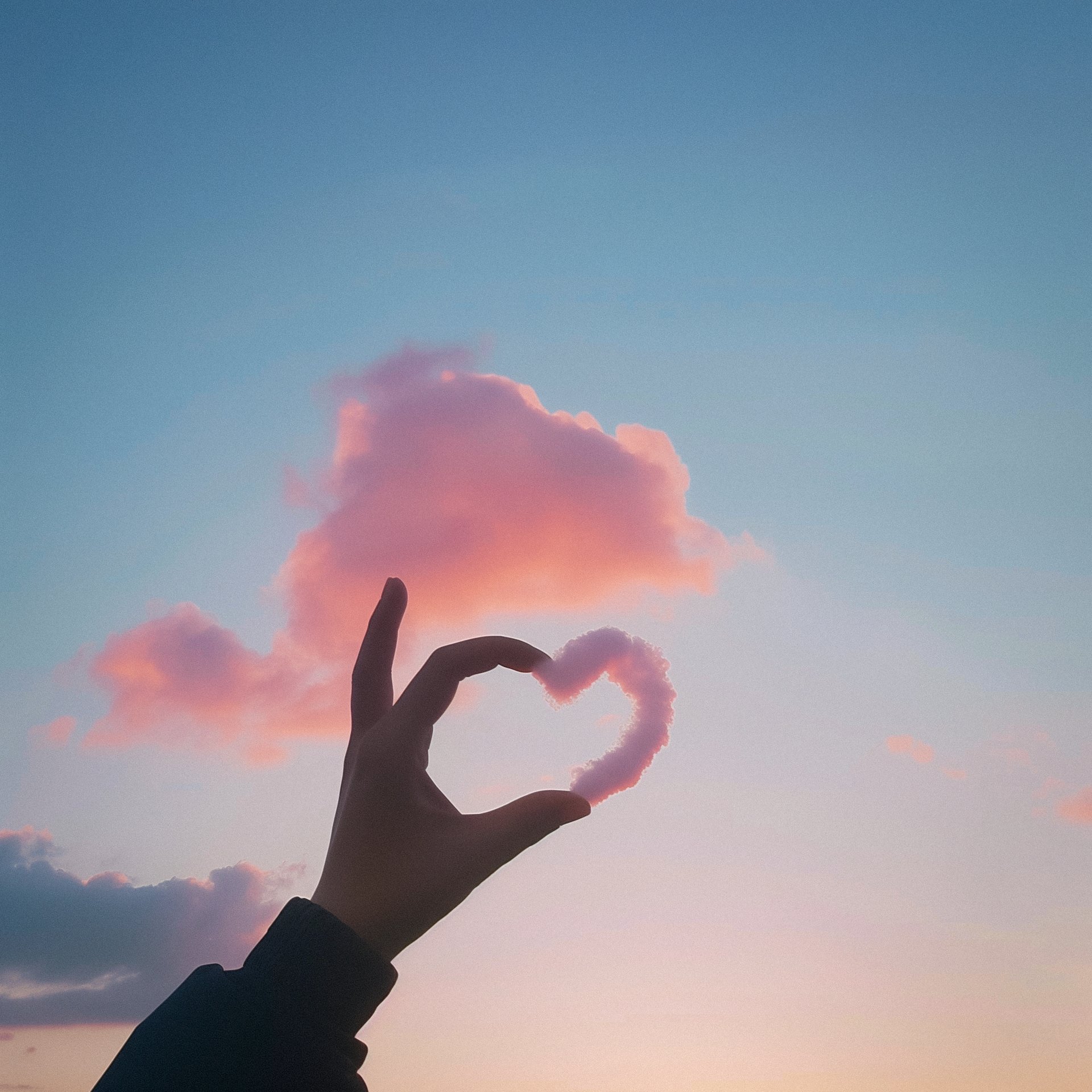 A hand and cloud forming heart
